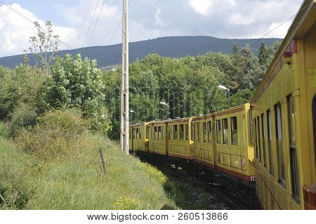 Latour De Carol - September 4, 2018: The Small Yellow Train Of The Pyrenees Crossing A Beautiful Mou