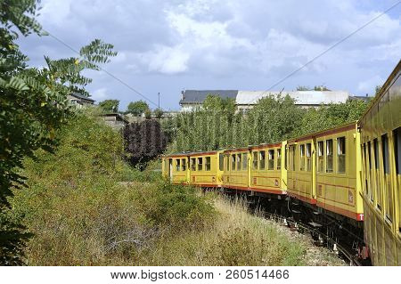 Latour De Carol - September 4, 2018: The Small Yellow Train Of The Pyrenees Crossing A Beautiful Mou
