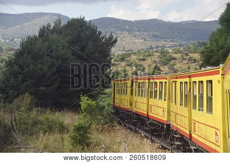 Latour De Carol - September 4, 2018: The Small Yellow Train Of The Pyrenees Crossing A Beautiful Mou