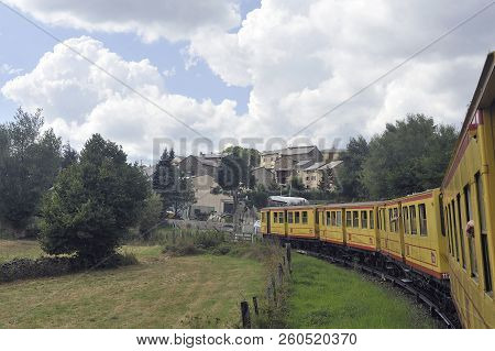 Latour De Carol - September 4, 2018: The Small Yellow Train Of The Pyrenees Crossing A Beautiful Mou