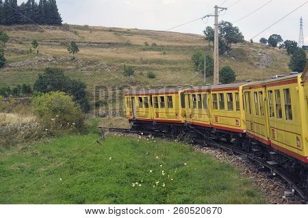 Latour De Carol - September 4, 2018: The Small Yellow Train Of The Pyrenees Crossing A Beautiful Mou