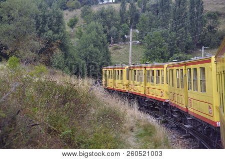 Latour De Carol - September 4, 2018: The Small Yellow Train Of The Pyrenees Crossing A Beautiful Mou