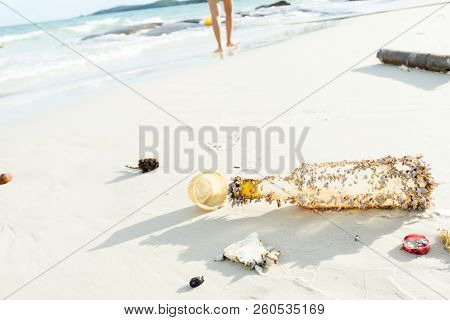 Trash And Dirt Are Left On The White Sand.