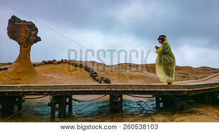 Happy Old Asian Women Wear A Rain Roat And Travel In Taipei Yehliu Geopark In Rainy Day,taiwan Trave