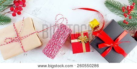 Christmas Decorative Background With Fir Branches, Cones, Redr And Black Christmas  Gifts, Ball On T