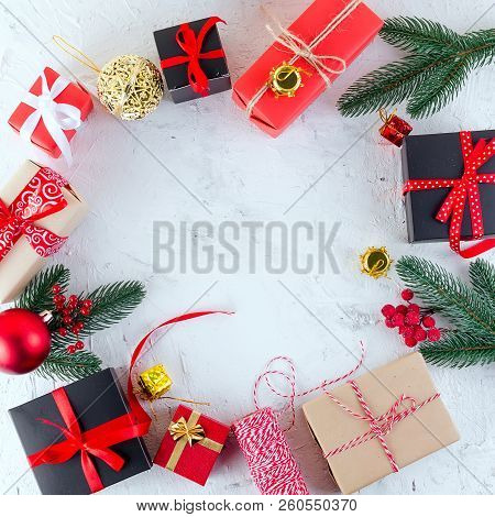 Christmas Decorative Background With Fir Branches, Cones, Redr And Black Christmas  Gifts, Ball On T