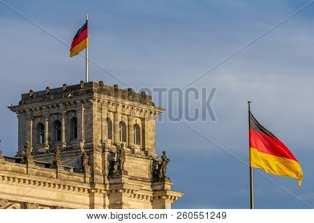 Federal Republic Of Germany, German National Flag At The Parliament Building Waving On The Blue Sky 