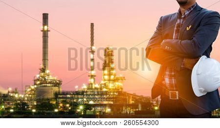 Engineers And Oil Refineries And Evening Lighting.