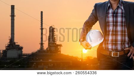 Engineers And Oil Refineries And Evening Lighting.