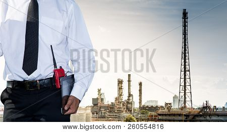 Engineers And Oil Refineries And Evening Lighting.