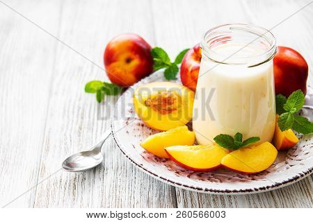 Yogurt With Fresh Nectarines On A White Wooden Table