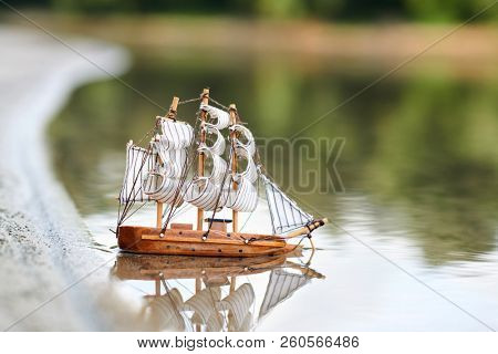 a toy sailing ship in the river