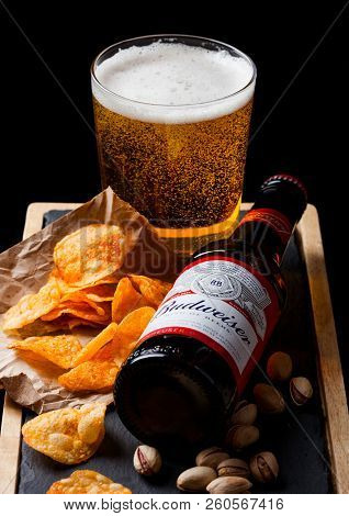 London, Uk - September 26, 2018: Bottle Of Budweiser Beer With Glass And Snack Ostone Board On Black