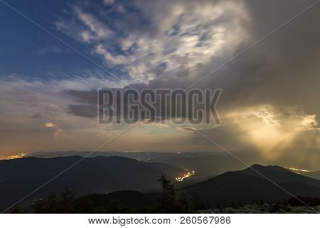 Beautiful Summer Night Panorama In Mountains. Wide View Of Starry Dark Blue Cloudy Sky Over Magnific