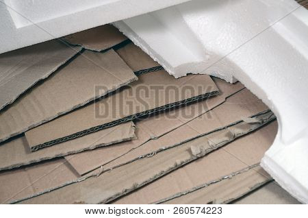 Background Image With A Lot Of Beige Cardboard Paper And Styrofoam Boxes Disgarded As Rubbish. The C