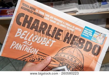 Montreal, Canada - September 14, 2018: Charlie Hebdo Newspaper In A Hand. Charlie Hebdo Is A French 