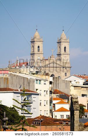 The Church Of Lapa At Porto As Seen From A Distance, Amidst Various Buildings.