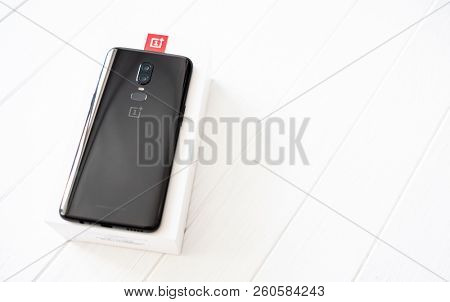 Khakiv, Ukraine - 14 August 2018: Smartphone OnePlus 6 on the white and red box and wooden table