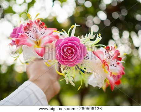 Tiara Of Artificial Frower In Hand. Selective Focus