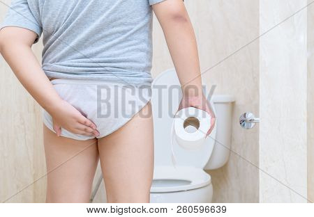 Child Has Diarrhea Holding His Butt In Toilet,diarrhea Constipation. Health And Cleanliness Concept