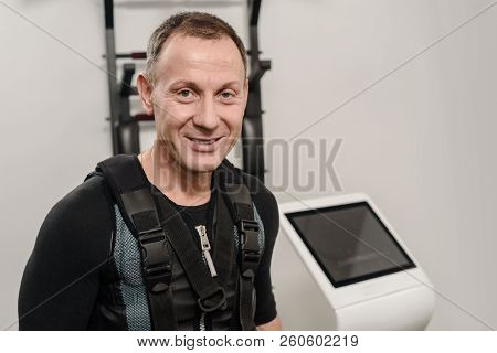 Coach Connecting Electrode On Ems Suit Of Athletic Man