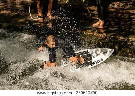 Munich, Germany - Sept 8, 2018: Man Surfing In The Waves Of The Eisbach River In Munich. It Forms A 
