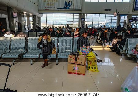 Yiwu/china - January 24 2015: Chinese People Wait For The Rocket Train To Go To Another City In Yiwu