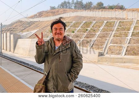 Asian Fat Traveler Show His Two Finger In The High Speed Train Planform In Yiwu Train Station China