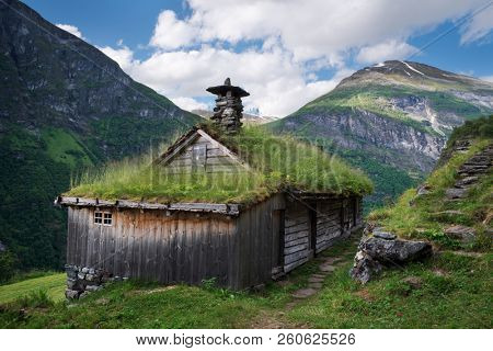 Kagefla - mountain farms on the mountainsides along the Geirangerfjorden fjord. Tourist attraction of Norway. Traditional Scandinavian turf houses