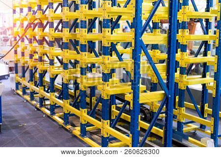 plastic boxes in the cells of the automated warehouse. Metal construction warehouse shelving