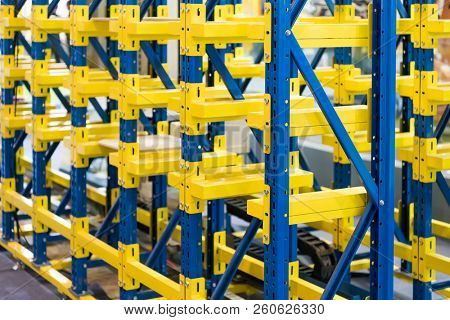  plastic boxes in the cells of the automated warehouse. Metal construction warehouse shelving