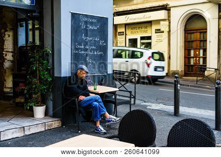 Marseilles, France - 2018. 
Old Man Having A Beer On A Terrace In Downtown Marseilles.