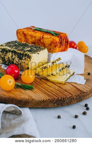 Cheese Halumi With Mint And Smoked Paprika On A Wooden Board With Tomatoes, Pepper And Rosemary