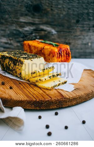 Cheese Halumi With Mint And Smoked Paprika On A Wooden Board With Pepper And Rosemary, Wooden Backgr