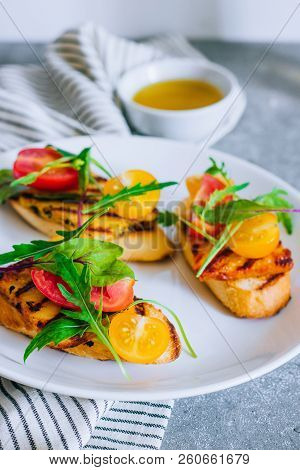 Bruschetta With Cherry Tomato Salad With Grilled Haloumi Cheese, With Chard And Arugula