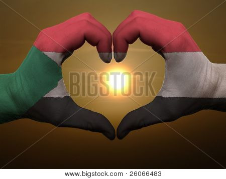 Cuore e amore gesto di mani colorate In Sudan bandiera durante la bella alba