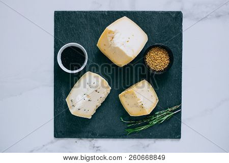Assorted сachotta Cheese With Black Cumin, Fenugreek And Herbs On Black Shale
