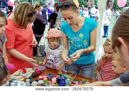 Zaporozhia/ukraine- June 2, 2018: Charity Family Festival-young Woman - Volunteer Explaining To Smal