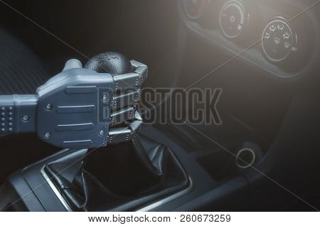 Robot Hand On Car Gearstick. Robot Pilot Is Driving A Car. Automatic Driver Concept.