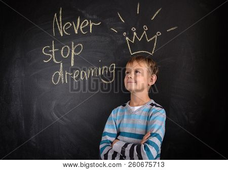 European Boy On The Background Of A Black Board With The Inscription 