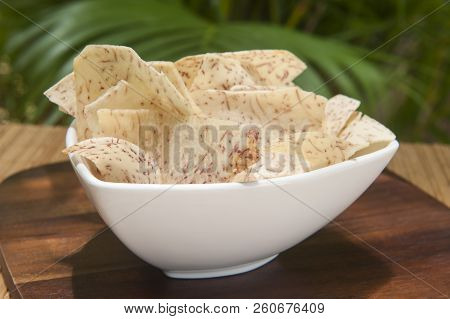 White Dish Of Malanga Chips Outside In The Tropical Garden