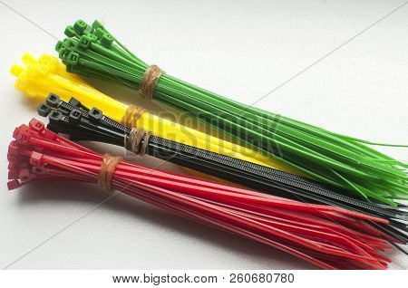 Different Colors Of Plastic Nylon Cable Ties With Self-locking Teeth Closeup On White Background