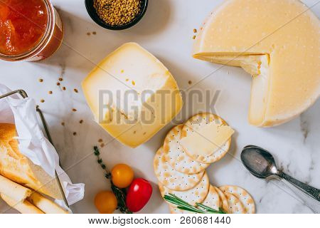 Cachotta Cheese With With Fenugreek, Jam, Baguette, Crackers, Rosemary And Thyme On Marble