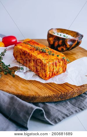 Cheese Halumi With Smoked Paprika On A Wooden Board With Tomatoes, And Thyme
