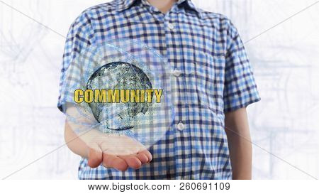 Young Man Shows A Hologram Of The Planet Earth And Text Community