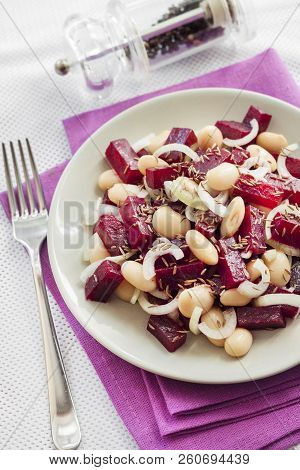 Beetroot Salad With White Kidney Beans, Pickles And Onion, Dressed With Oil And Flavored With Carawa