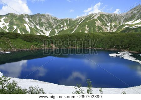 Mikurigaike Pond And Tateyama Mountain Range With Snow In Summer In Toyama, Japan