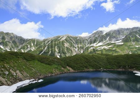 Mikurigaike Pond And Tateyama Mountain Range With Snow In Summer In Toyama, Japan