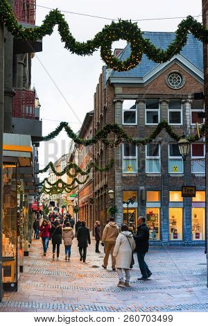 AACHEN, GERMANY - November 19, 2017: Tourists on foot Street in Aachen, Germany. Aachen was a residence of Charlemagne, and later the coronation place for German kings, Aachen, Germany