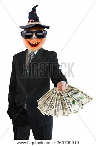 Portrait Of Jack Lantern  From Pumpkin In Black Business Suit. Jack Lantern Keeps Money In His Hands